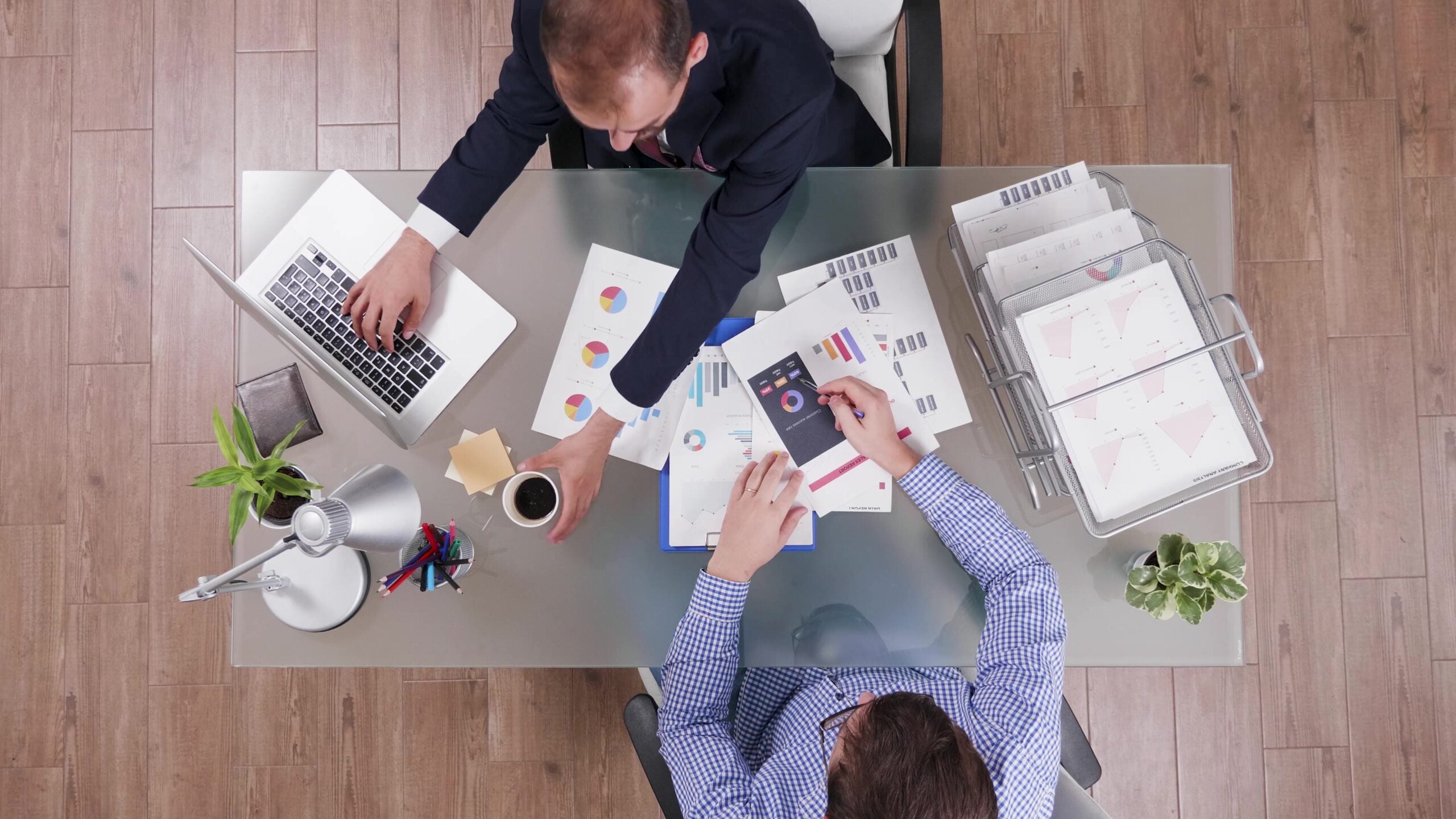 top-view-of-businessman-in-suit-drinking-coffee-during-collaboration-meeting-scaled.jpg